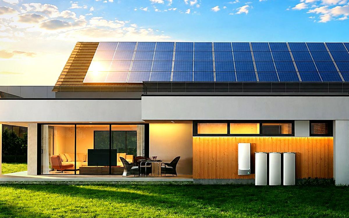 A solar-powered home with warm interior lights in the evening